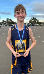 Northholm Grammar male netball goal attack showing his trophy